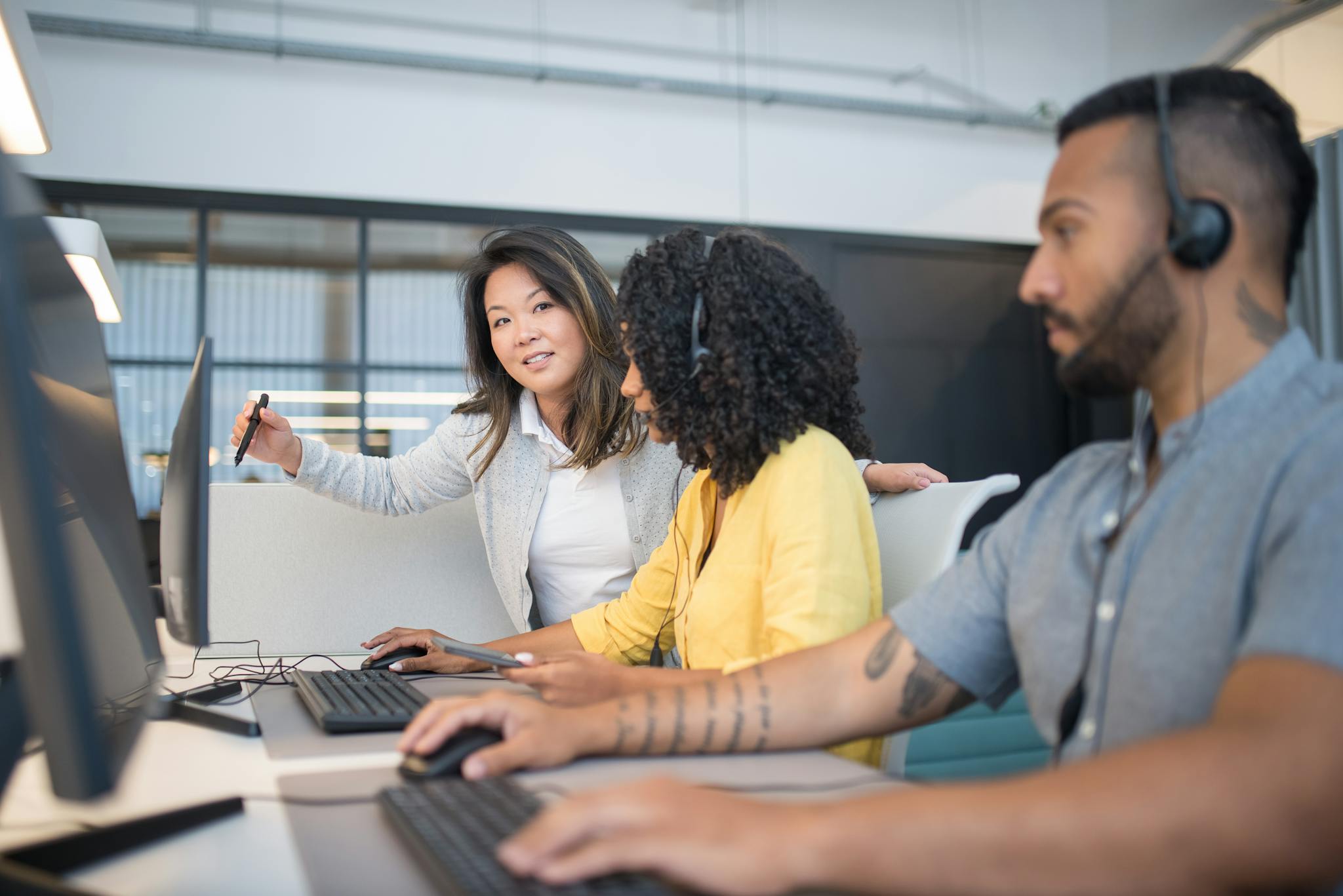 A diverse group of professionals collaborating in a modern call center setting.